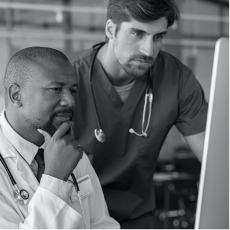 Healthcare professionals looking at a computer.